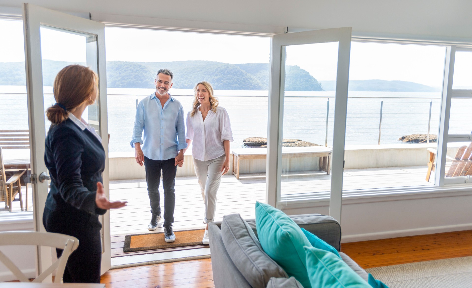Real estate agent showing a mature couple a new house.